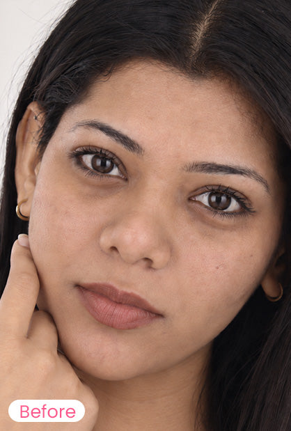 A close-up portrait of a woman with dark hair and natural skin tone